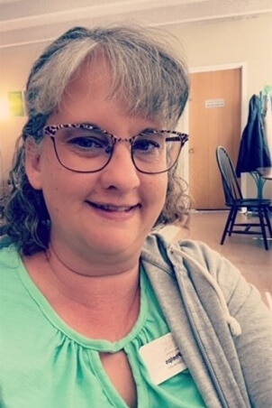 woman with grey hair and green shirt ellen phelps