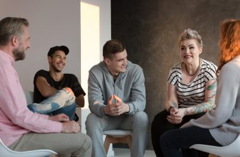 Teenagers laughing during a group counseling session for youth Teenagers laughing during a group counseling session for youth with emotional and behavioral problems.