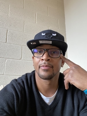 male in black hat with glasses