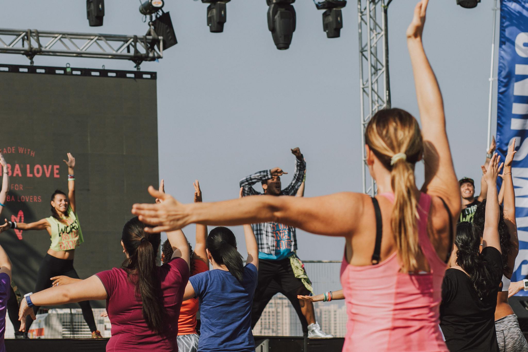 A Woman in Pink Tank Top Raising Her Hands